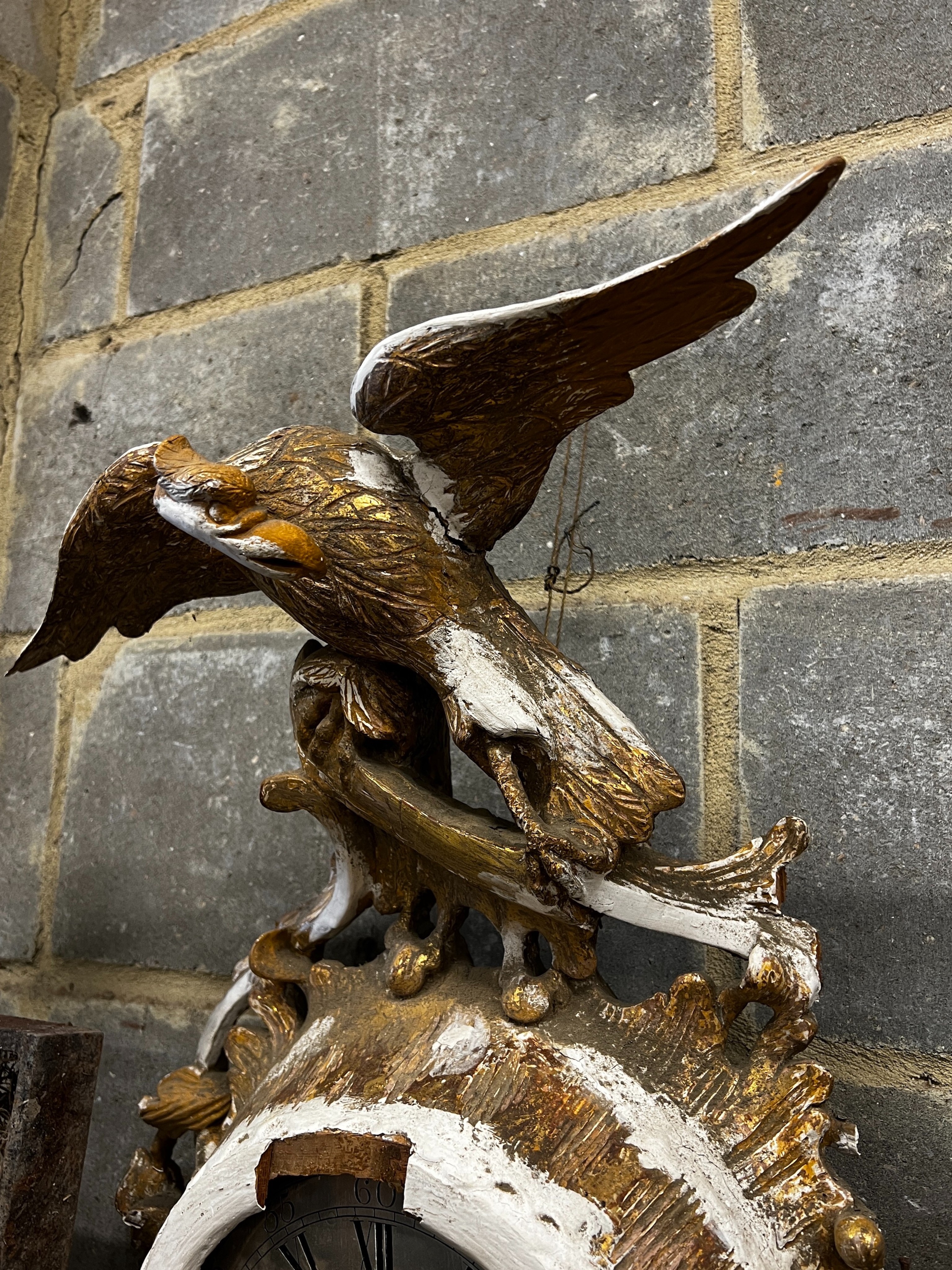 An early 19th century carved giltwood single fusee wall timepiece, silvered dial marked Thomas Wagstaffe, London. Case in need of restoration, height 78cm